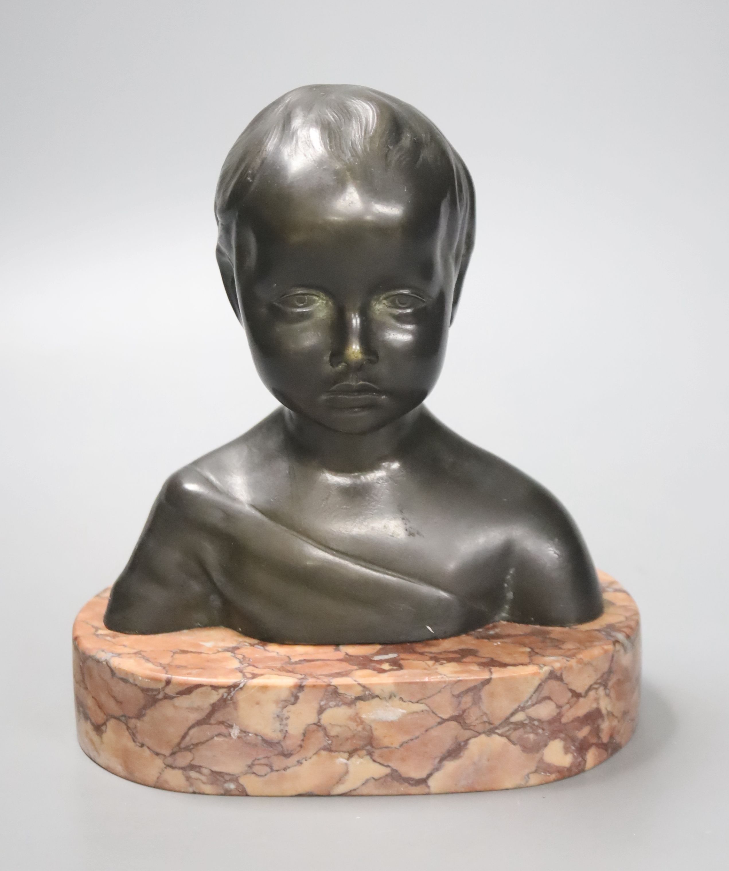 An early 20th century Continental bronze bust of a young girl, on a polished red marble base, 17cm high